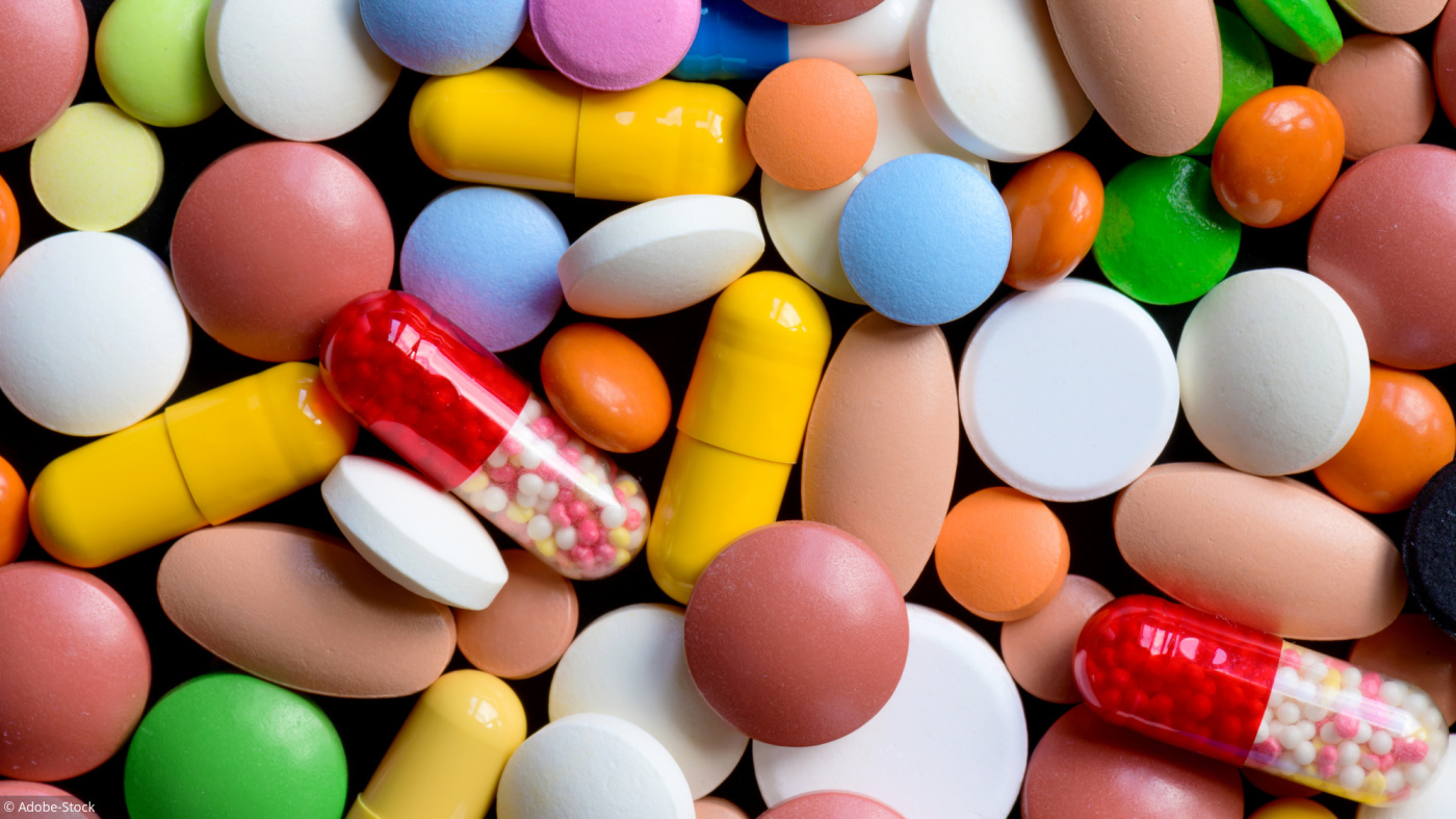 Different colorful pills and drugs background. Medicinal tablets, capsules and pills. Top view